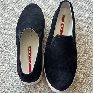 Black Suede Prada Slip Ons. Comes with dust bag and box